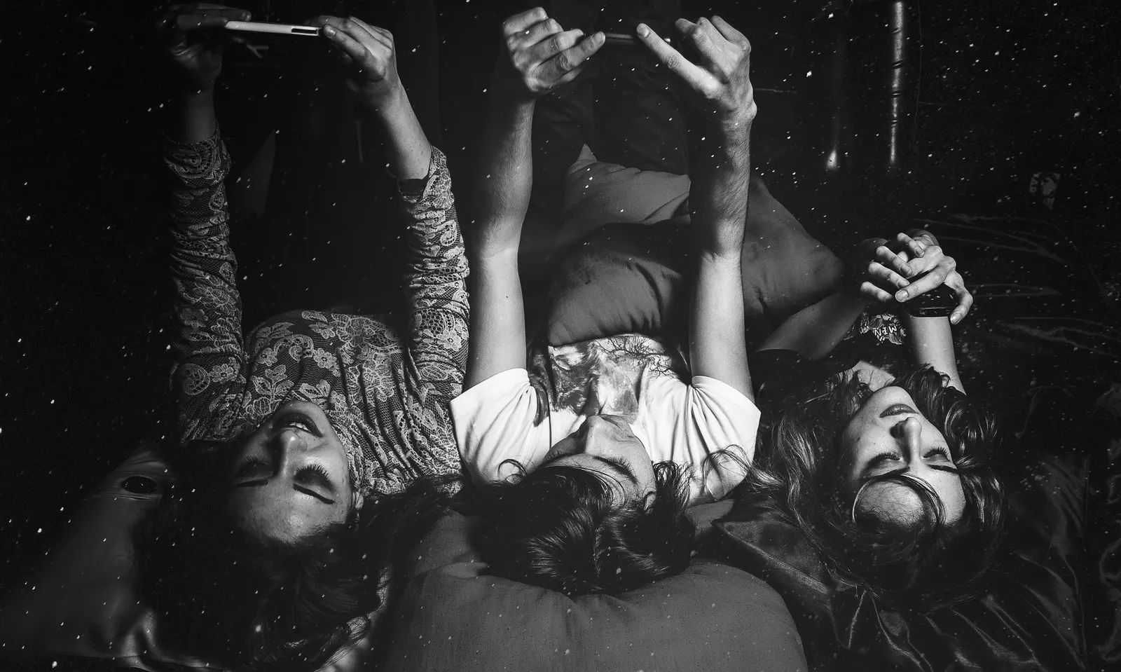 Friends gathered around a smartphone during a game